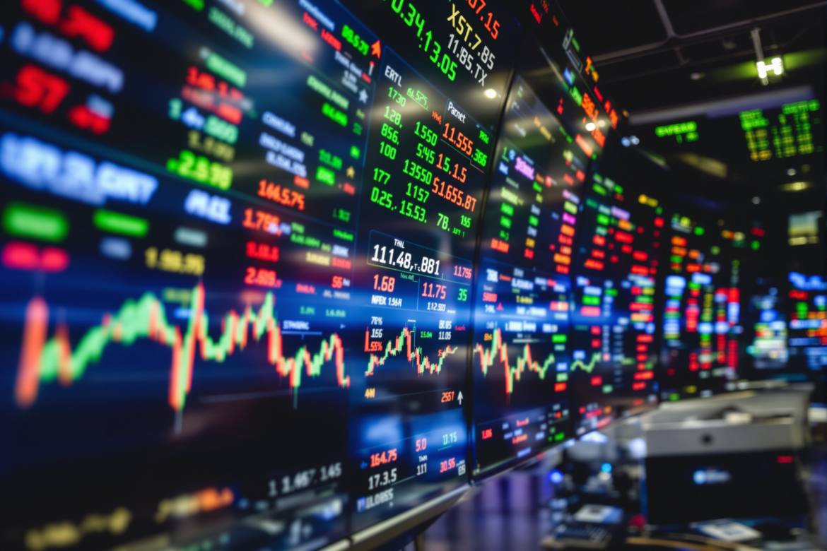 A dynamic stock market trading floor with screens showing fluctuating indices and a focus on technology sector stocks.